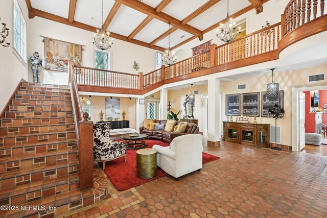 16 May St, Saint Augustine, FL 32084 - living room with a chandelier, a high ceiling, beam ceiling, plenty of natural light, and stairs