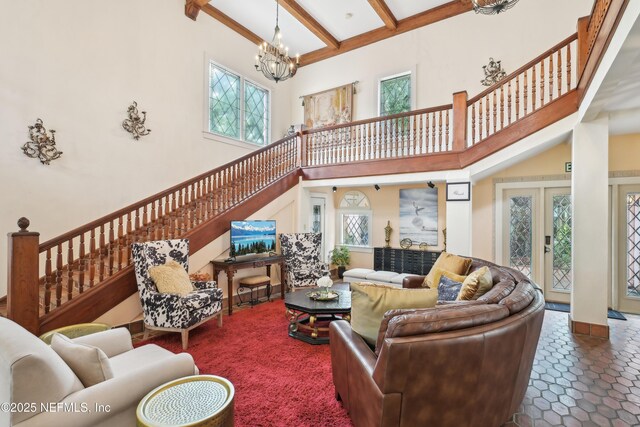 16 May St, Saint Augustine, FL 32084 - living room with a chandelier, a towering ceiling, beamed ceiling, stairway, and tile patterned flooring