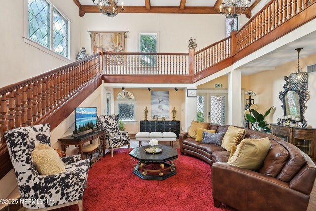 16 May St, Saint Augustine, FL 32084 - living area featuring a chandelier, plenty of natural light, a high ceiling, and stairway
