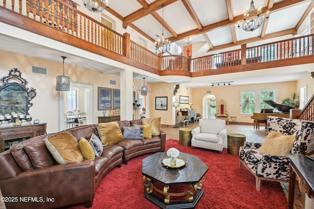 16 May St, Saint Augustine, FL 32084 - living room featuring a chandelier, beam ceiling, a high ceiling, baseboards, and carpet