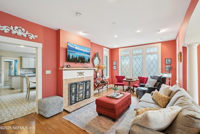 16 May St, Saint Augustine, FL 32084 - living area featuring wood finished floors, a fireplace, decorative columns, and recessed lighting