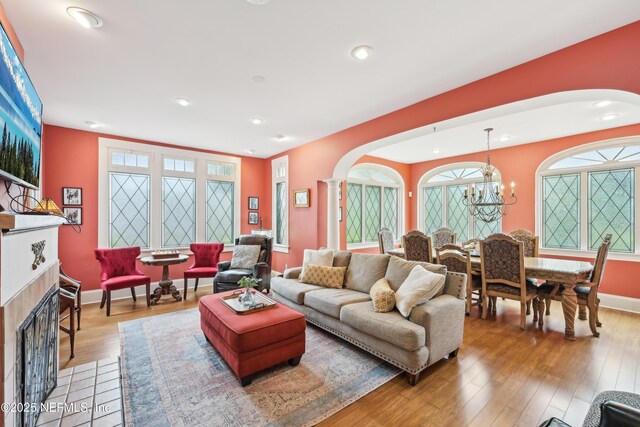 16 May St, Saint Augustine, FL 32084 - living room with arched walkways, light wood-style flooring, a chandelier, ornate columns, and recessed lighting