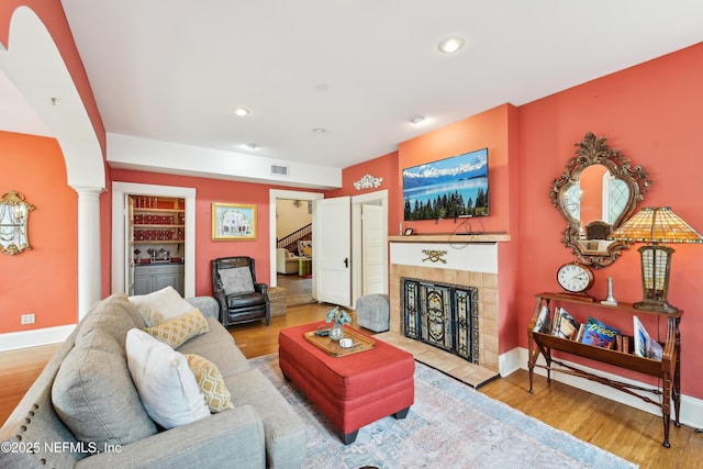 16 May St, Saint Augustine, FL 32084 - living area with wood finished floors, a fireplace, recessed lighting, ornate columns, and baseboards