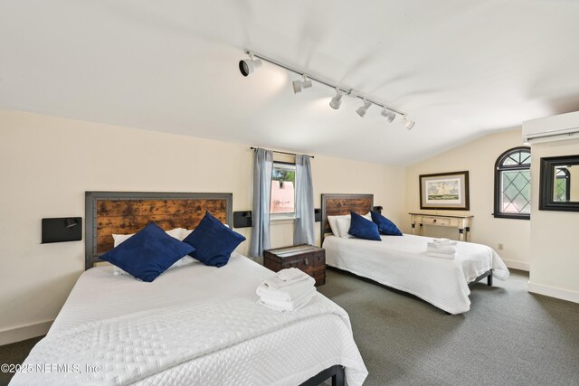 16 May St, Saint Augustine, FL 32084 - carpeted bedroom featuring rail lighting, baseboards, and lofted ceiling