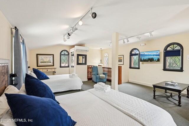 16 May St, Saint Augustine, FL 32084 - bedroom featuring track lighting, a wall mounted air conditioner, dark carpet, and baseboards