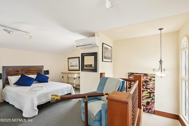 16 May St, Saint Augustine, FL 32084 - carpeted bedroom with an AC wall unit, lofted ceiling, track lighting, and baseboards