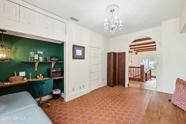 16 May St, Saint Augustine, FL 32084 - bedroom featuring a chandelier, arched walkways, beamed ceiling, dark tile patterned flooring, and baseboards