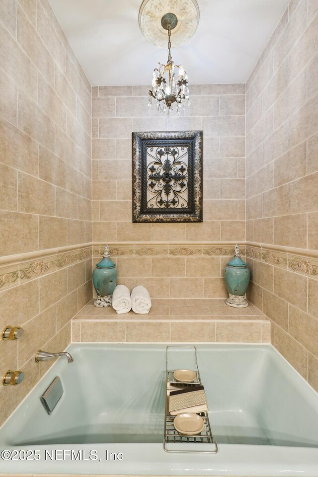 16 May St, Saint Augustine, FL 32084 - bathroom featuring a garden tub and a chandelier