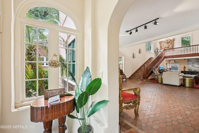 16 May St, Saint Augustine, FL 32084 - doorway to outside featuring arched walkways, rail lighting, stairs, and plenty of natural light