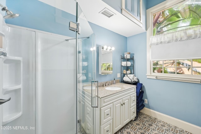 16 May St, Saint Augustine, FL 32084 - bathroom with healthy amount of natural light, a stall shower, vanity, and baseboards