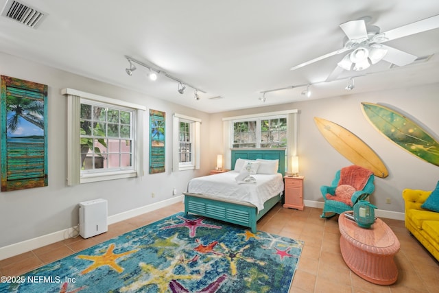 16 May St, Saint Augustine, FL 32084 - bedroom featuring light tile patterned floors, track lighting, baseboards, and ceiling fan