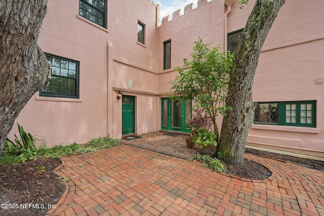 16 May St, Saint Augustine, FL 32084 - doorway to property with stucco siding and a patio