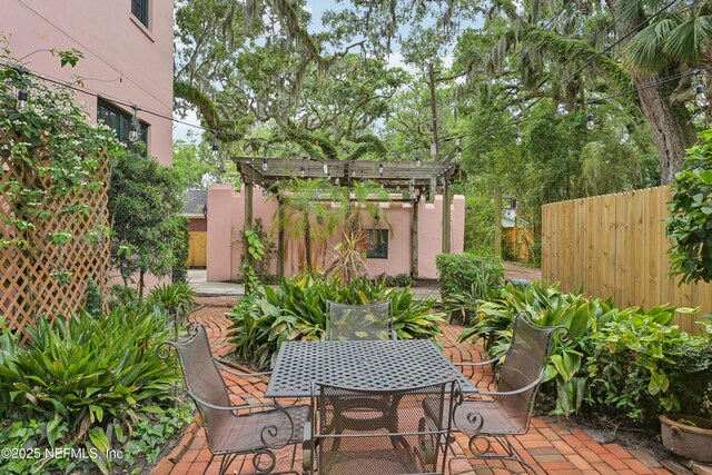 16 May St, Saint Augustine, FL 32084 - view of patio / terrace featuring outdoor dining space, a pergola, and fence