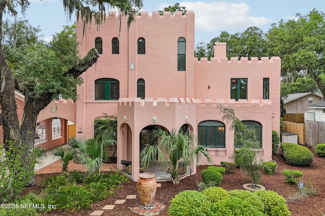 16 May St, Saint Augustine, FL 32084 - view of front of home with stucco siding, fence, and central AC unit