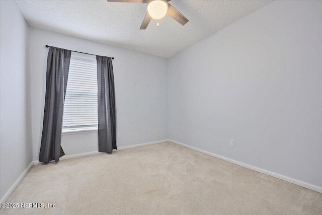 unfurnished room featuring carpet, a ceiling fan, baseboards, and a textured ceiling