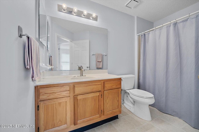 full bath featuring toilet, vanity, tile patterned flooring, a textured ceiling, and curtained shower