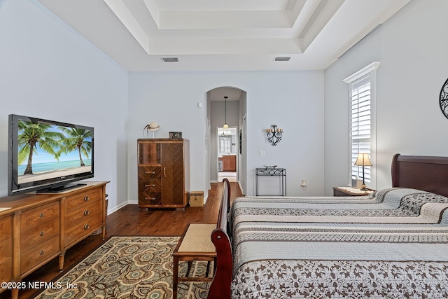 232 Porta Rosa Cir, Saint Augustine, FL 32092 - bedroom featuring arched walkways, dark wood finished floors, a raised ceiling, and baseboards