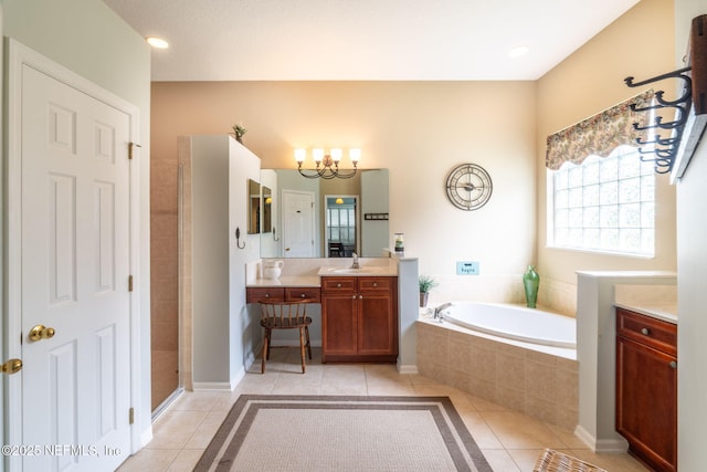 232 Porta Rosa Cir, Saint Augustine, FL 32092 - bathroom with tile patterned flooring, a bath, a chandelier, vanity, and a tile shower