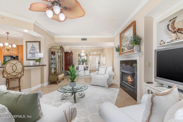 425 N Ocean Grande Dr Unit 205, Ponte Vedra Beach, FL 32082 - living room featuring a chandelier, light tile patterned floors, ornamental molding, a glass covered fireplace, and a ceiling fan