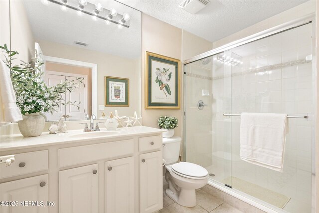 425 N Ocean Grande Dr Unit 205, Ponte Vedra Beach, FL 32082 - bathroom with a stall shower, toilet, vanity, tile patterned floors, and a textured ceiling
