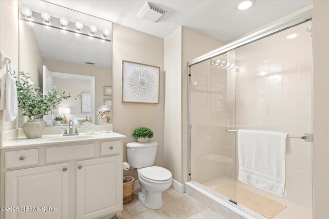 425 N Ocean Grande Dr Unit 205, Ponte Vedra Beach, FL 32082 - full bath featuring toilet, a stall shower, vanity, tile patterned floors, and a textured ceiling