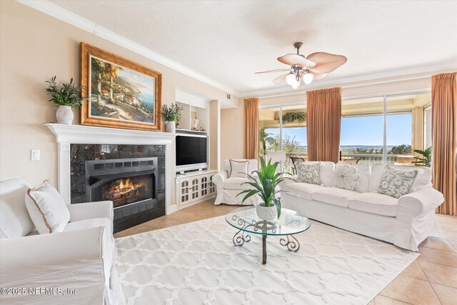 425 N Ocean Grande Dr Unit 205, Ponte Vedra Beach, FL 32082 - living room with tile patterned flooring, ornamental molding, a fireplace, and a ceiling fan