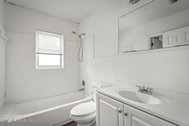 7972 Waxwing Ave, Jacksonville, FL 32219 - bathroom featuring toilet, bathtub / shower combination, vanity, and tile walls