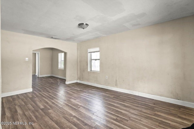 7972 Waxwing Ave, Jacksonville, FL 32219 - empty room with wood finished floors, arched walkways, and baseboards