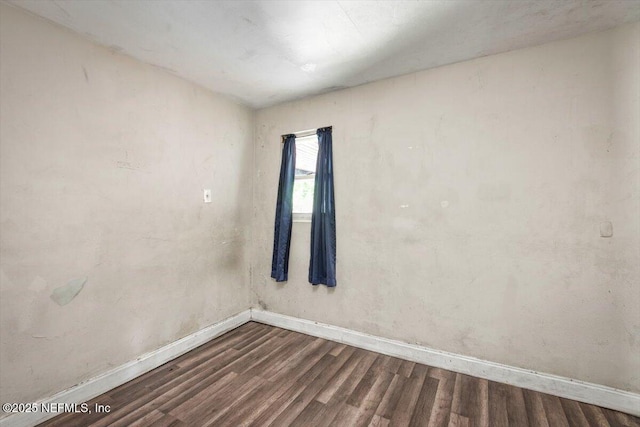 7972 Waxwing Ave, Jacksonville, FL 32219 - spare room with baseboards and dark wood-type flooring