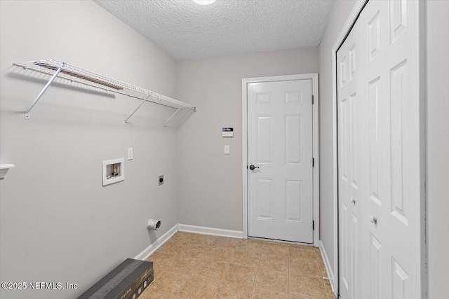 663 Reflection Cove Ct, Jacksonville, FL 32218 - clothes washing area featuring hookup for a washing machine, electric dryer hookup, a textured ceiling, and baseboards