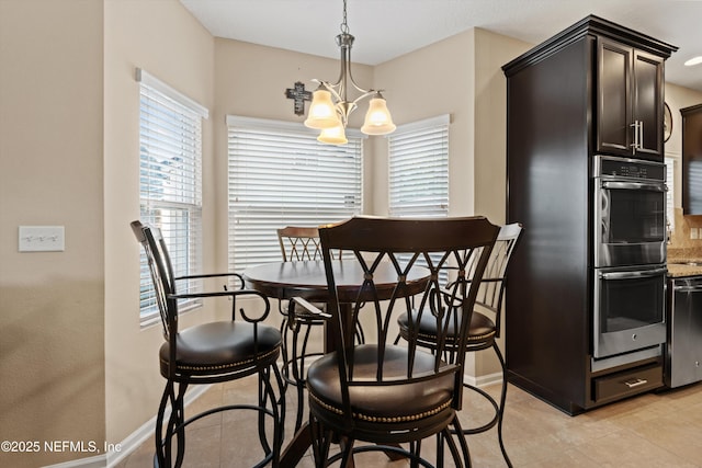 4008 Cormorant Ln, Middleburg, FL 32068 - dining room featuring a chandelier, light tile patterned flooring, and baseboards