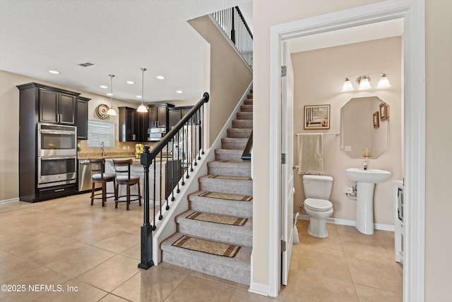 4008 Cormorant Ln, Middleburg, FL 32068 - stairs with tile patterned flooring, recessed lighting, and baseboards