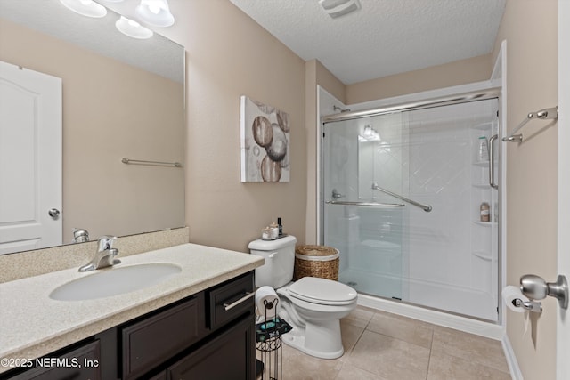 4008 Cormorant Ln, Middleburg, FL 32068 - bathroom with a textured ceiling, a stall shower, tile patterned floors, toilet, and vanity