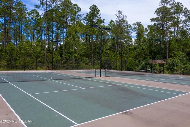 4008 Cormorant Ln, Middleburg, FL 32068 - view of tennis court with community basketball court, fence, and a view of trees