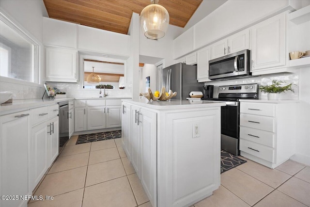 188 Sea Hammock Way Unit 188, Ponte Vedra Beach, FL 32082 - kitchen featuring stainless steel appliances, wooden ceiling, light tile patterned floors, tasteful backsplash, and white cabinets