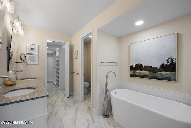 188 Sea Hammock Way Unit 188, Ponte Vedra Beach, FL 32082 - bathroom with double vanity, marble look tiles, a soaking tub, a walk in closet, and recessed lighting