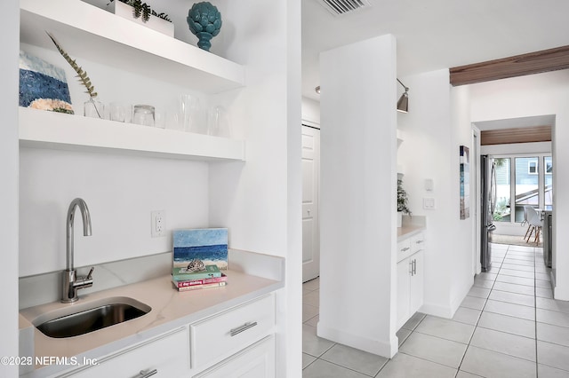 188 Sea Hammock Way Unit 188, Ponte Vedra Beach, FL 32082 - kitchen featuring open shelves, freestanding refrigerator, a sink, light countertops, and white cabinetry