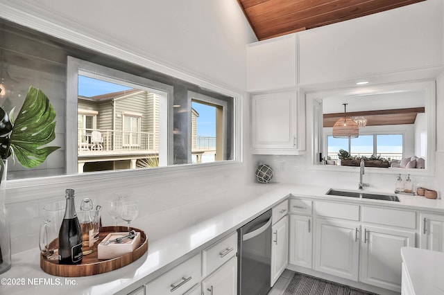 188 Sea Hammock Way Unit 188, Ponte Vedra Beach, FL 32082 - kitchen with a sink, stainless steel dishwasher, decorative backsplash, white cabinetry, and wood ceiling