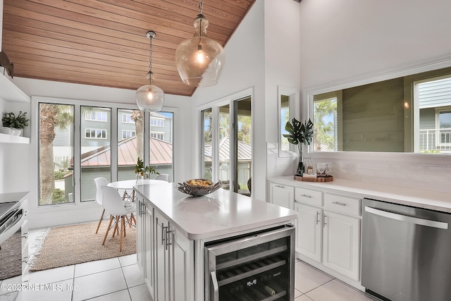188 Sea Hammock Way Unit 188, Ponte Vedra Beach, FL 32082 - kitchen with stainless steel appliances, beverage cooler, light tile patterned floors, wood ceiling, and light countertops