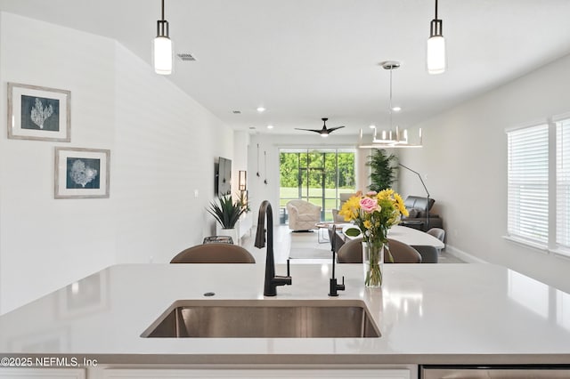 1459 Stillwater Blvd, Saint Johns, FL 32259 - kitchen with a sink, open floor plan, a ceiling fan, hanging light fixtures, and light countertops