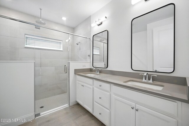 1459 Stillwater Blvd, Saint Johns, FL 32259 - bathroom featuring a stall shower, double vanity, recessed lighting, and wood finish floors