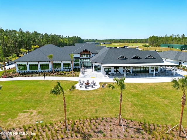 1459 Stillwater Blvd, Saint Johns, FL 32259 - back of house featuring a fire pit, a lawn, and a patio