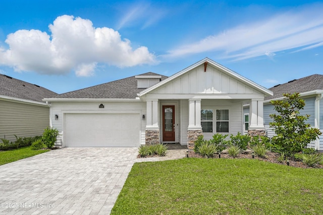 1459 Stillwater Blvd, Saint Johns, FL 32259 - craftsman inspired home featuring board and batten siding, a front yard, decorative driveway, a garage, and roof with shingles
