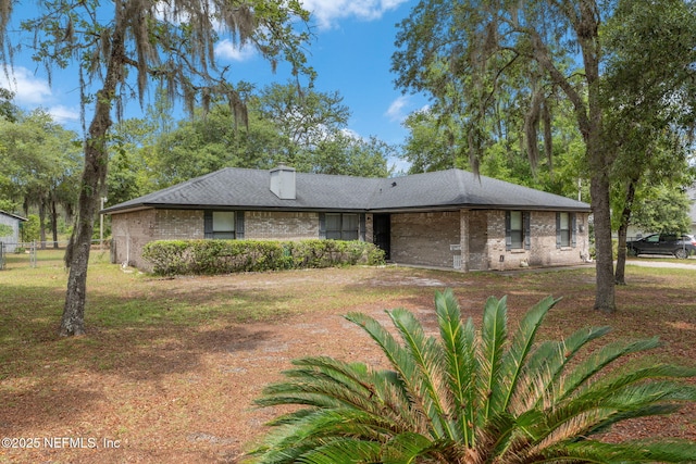 2658 Apache Ct, Middleburg, FL 32068 - view of front of home featuring brick siding and a chimney