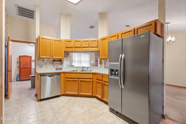 2658 Apache Ct, Middleburg, FL 32068 - kitchen featuring stainless steel appliances, a sink, light countertops, a chandelier, and a towering ceiling