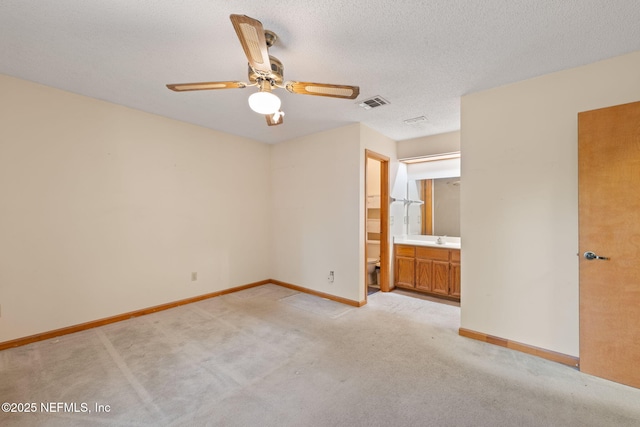 2658 Apache Ct, Middleburg, FL 32068 - unfurnished bedroom with light colored carpet, baseboards, ensuite bathroom, and a ceiling fan