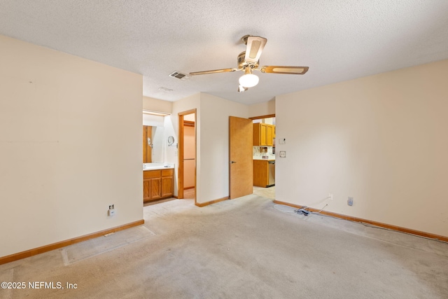 2658 Apache Ct, Middleburg, FL 32068 - unfurnished bedroom with light colored carpet, baseboards, a textured ceiling, ensuite bath, and ceiling fan