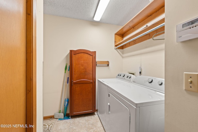 2658 Apache Ct, Middleburg, FL 32068 - clothes washing area with washing machine and clothes dryer, a textured ceiling, and light tile patterned floors