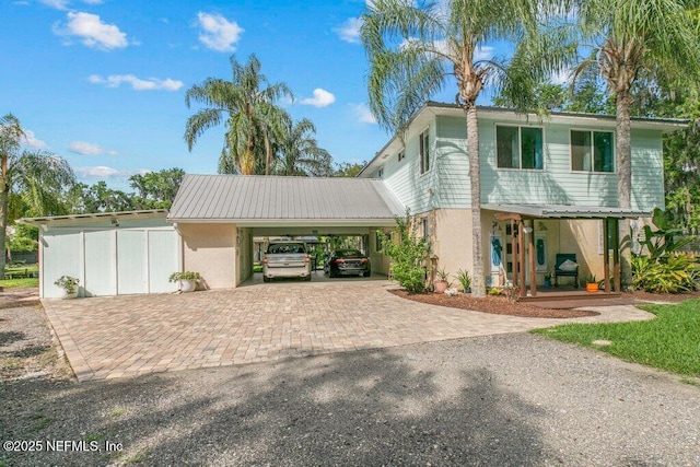 8211 Colee Cove Branch Rd Unit G, Saint Augustine, FL 32092 - view of front of home with decorative driveway, covered porch, a carport, metal roof, and stucco siding