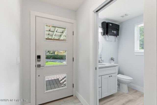 8211 Colee Cove Branch Rd Unit G, Saint Augustine, FL 32092 - half bath featuring toilet, vanity, baseboards, and wood finished floors